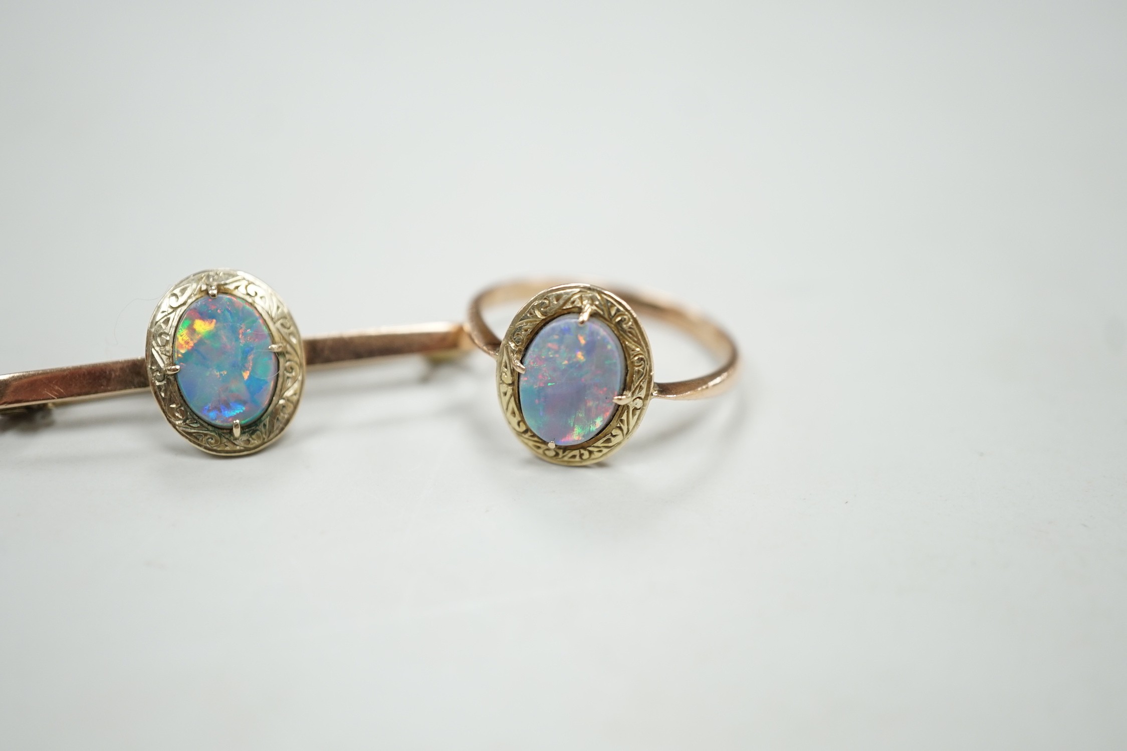 A 9ct and black opal doublet set bar brooch, 38mm and a matching ring, size R, gross weight 5.9 grams.